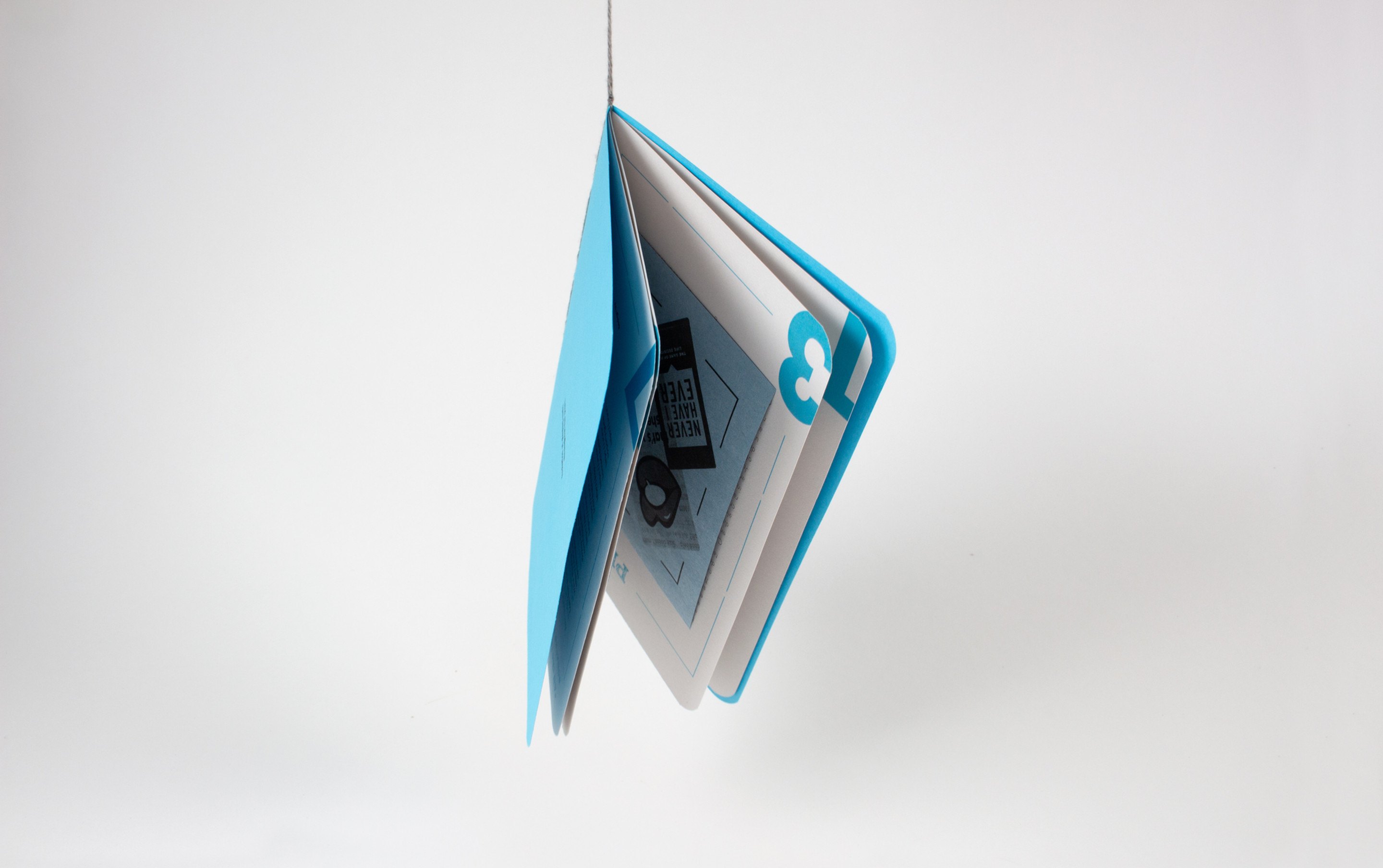 The blue book stood open on its end with the pages fanned, the number 5 showing through the cover