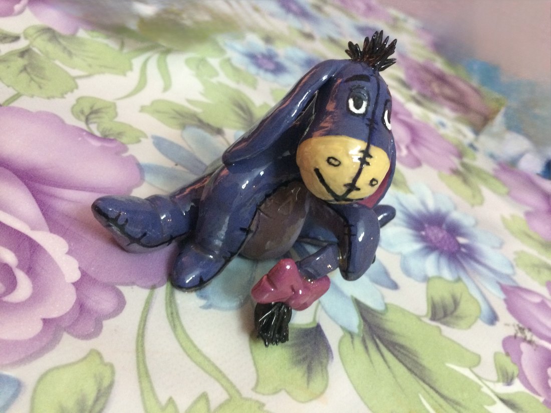 An Eeyore figure on floral fabric