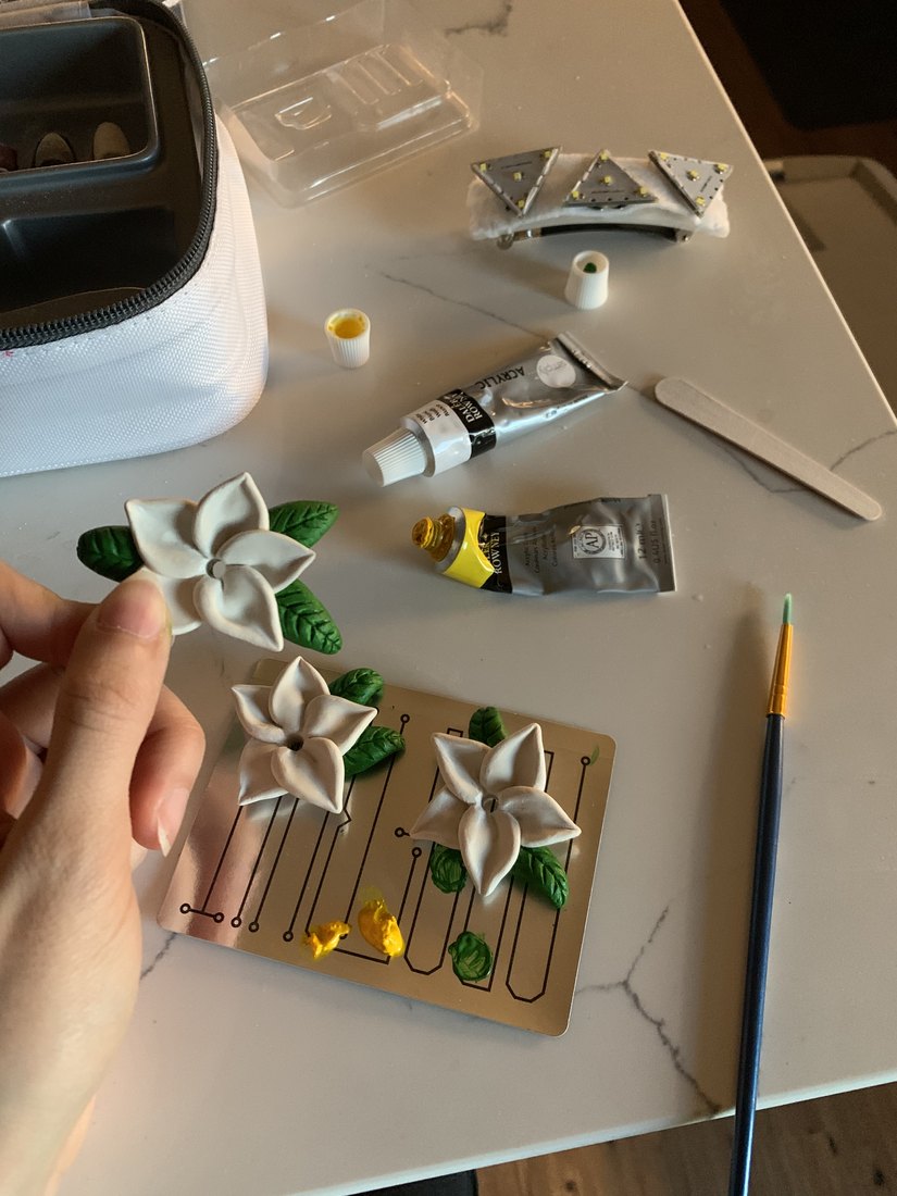 Frangipani flowers being painted at the bench