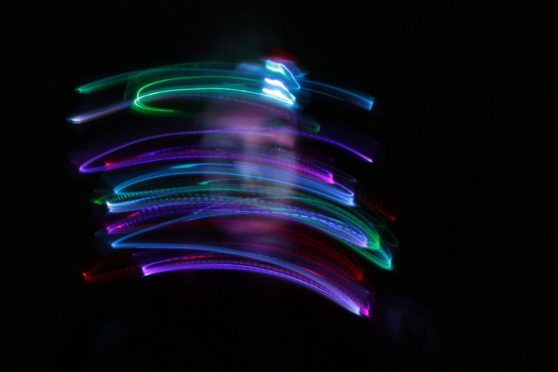 Stacked arcs of light crossing a face