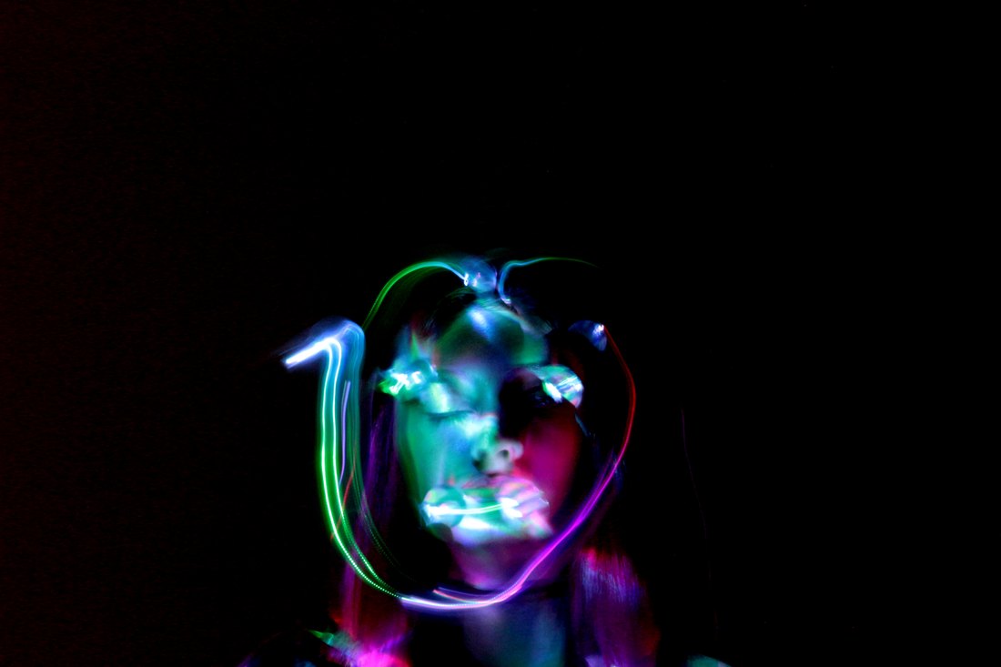 A mask of light traced around a face