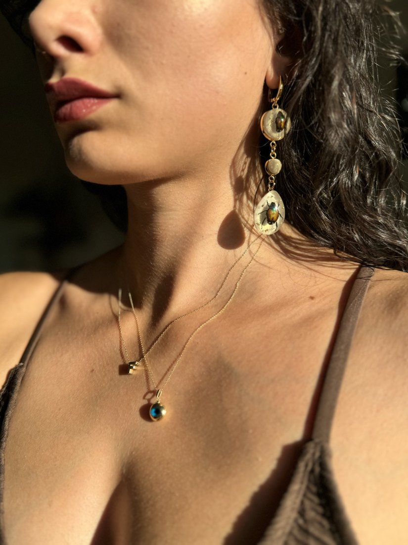 The resin earrings and necklace being worn