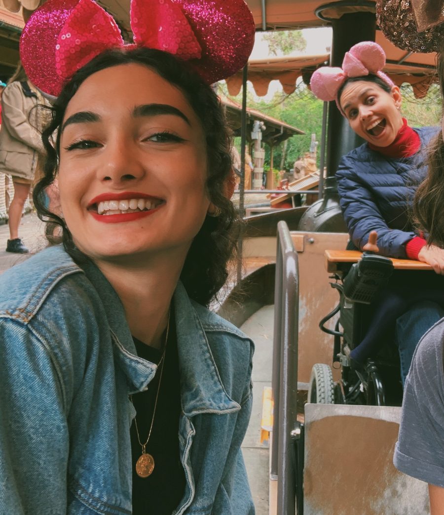 Fidan and her friend Maria at Disney, both wearing sequinned Minnie Mouse ears.