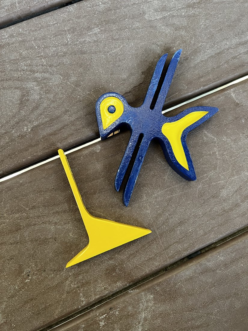 The 3D printed logo and its stand before assembly