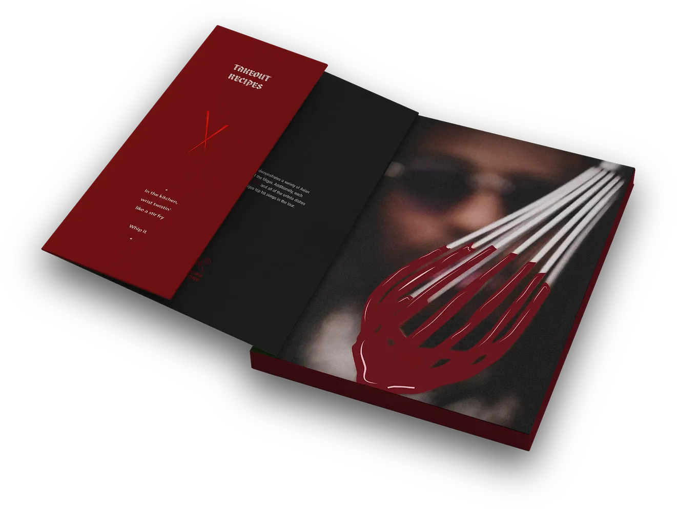 The inside cover opened out: a deep red panel of type, then a black panel, then a close photograph of a red whisk held up in front of a face