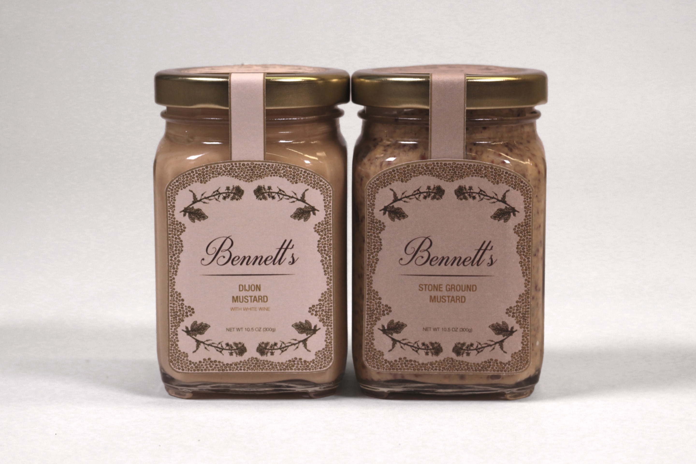 Two Bennett’s mustard jars, Dijon and stone ground, front labels facing the camera
